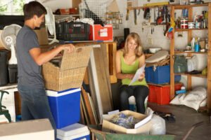 young couple sorting through belongings for garage sale
